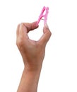 Woman hand pressing pink plastic cloth clip, isolated white background Royalty Free Stock Photo