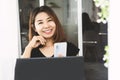 Happy Asian woman hand using technology mobile phone and laptop for start up business Royalty Free Stock Photo