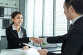 Asian woman handshake with hr manager after job interview in office. Attractive beautiful female employee shake hands with human