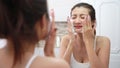 Asian woman happy cleanses the skin with foam in bathroom