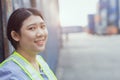 Asian woman happy dock worker control loading containers cargo at shipyard. Marine and carrier staff manager employee. cargo