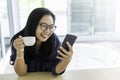 Asian woman happy smiling with smartphone and coffee cup
