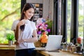 Asian woman or a happy student smiles on a desk with a computer Royalty Free Stock Photo