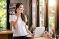 Asian woman or a happy student smiles on a desk with a computer Royalty Free Stock Photo