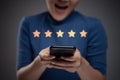 Asian woman happy using smart phone for check feedback, reviews with five stars icon hologram effect