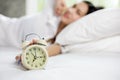 Asian woman happy wake up and turning off the alarm clock having Royalty Free Stock Photo