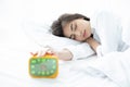 asian woman happy waking up and turning off the alarm clock having a good day Royalty Free Stock Photo