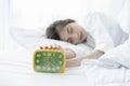 asian woman happy waking up and turning off the alarm clock having a good day Royalty Free Stock Photo