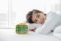 asian woman happy waking up and turning off the alarm clock having a good day Royalty Free Stock Photo