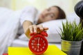 Asian woman happy waking up and turning off the alarm clock having a good day Royalty Free Stock Photo