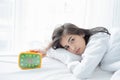 Asian woman happy waking up and turning off the alarm clock having a good day Royalty Free Stock Photo