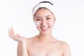 Asian woman has beauty face skin and nice skin. Asian woman show and hold product of cream, lotion with smiley face. Smiling Asia