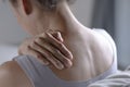 Asian woman has shoulder pain. Female holding painful shoulder with another hand. People with body-muscles problem