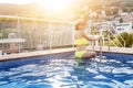 Asian Woman in hat nejoying vacation in swimming pool on the roof Royalty Free Stock Photo