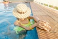 asian Woman in hat nejoying vacation in swimming pool on the roof Royalty Free Stock Photo