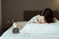 Asian women hates getting stressed waking up early 6 o`clock,Alarm clock,Weekend morning