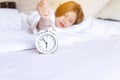 Asian woman hates getting stressed waking up late 6 o`clock,Alarm clock,Weekend morning