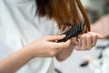 Asian woman have problem with long hair loss attach to comb brush Royalty Free Stock Photo