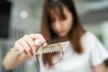 Asian woman have problem with long hair loss attach to comb brush Royalty Free Stock Photo