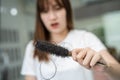 Asian woman have problem with long hair loss attach to comb brush Royalty Free Stock Photo