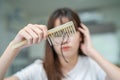 Asian woman have problem with long hair loss attach to comb brush Royalty Free Stock Photo