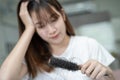 Asian woman have problem with long hair loss attach to comb brush Royalty Free Stock Photo