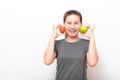 Asian woman having fun with green apple and tomato Royalty Free Stock Photo