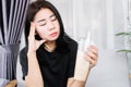 Closeup Asian woman having a headache and dizzy after drinking ice coffee, headache triggered by caffeine concept Royalty Free Stock Photo