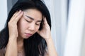 Stressed Asian woman having headache, migraine hand holding her head feeling pain and tired Royalty Free Stock Photo