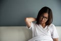 Asian woman having neck pain on her bed. Royalty Free Stock Photo