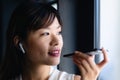 Asian woman having a phone call and looking outside Royalty Free Stock Photo