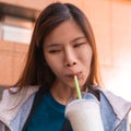 Asian Woman having pleasure time drinking milkshake