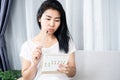 Asian woman having problem with amenorrhea, irregular periods looking at calendar and counting her menstrual cycles Royalty Free Stock Photo