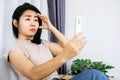 Asian woman having problem with farsighted trying to read text on smart phone with blurred eye vision Royalty Free Stock Photo