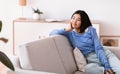 Asian woman having rest at home on the couch Royalty Free Stock Photo