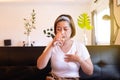 Asian woman having or symptomatic reflux acids,Gastroesophageal reflux disease,Drinking water Royalty Free Stock Photo