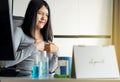 Asian woman having or symptomatic reflux acids during working at home