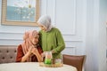 Asian woman in hijab sympathizes and calms her sad friend