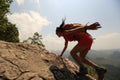 Asian woman hiker climbing rock on mountain peak cliff Royalty Free Stock Photo