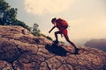 Asian woman hiker climbing rock on mountain peak cliff Royalty Free Stock Photo