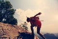 asian woman hiker climbing rock on mountain peak cliff Royalty Free Stock Photo