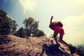 asian woman hiker climbing rock on mountain peak cliff Royalty Free Stock Photo