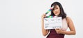 Asian woman hold clapperboard or movie slate on white background.She have tan skin show film movies or cinema production .