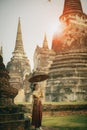 asian woman holding bamboo umbrella standing against stupa in ancient temple of ayutthaya world heritage site of unesco central of Royalty Free Stock Photo