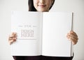 An Asian woman is holding a blank magazine Royalty Free Stock Photo