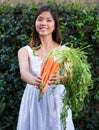 Asian woman holding a bunch of carrots Royalty Free Stock Photo