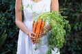 Asian woman holding a bunch of carrots Royalty Free Stock Photo