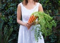 Asian woman holding a bunch of carrots Royalty Free Stock Photo