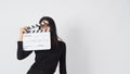 Asian woman is holding clapper board or movie slate or clapboard use in video production ,film, movie,cinema industry on white Royalty Free Stock Photo