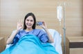 Asian woman holding credit card while stay on bed in hospital